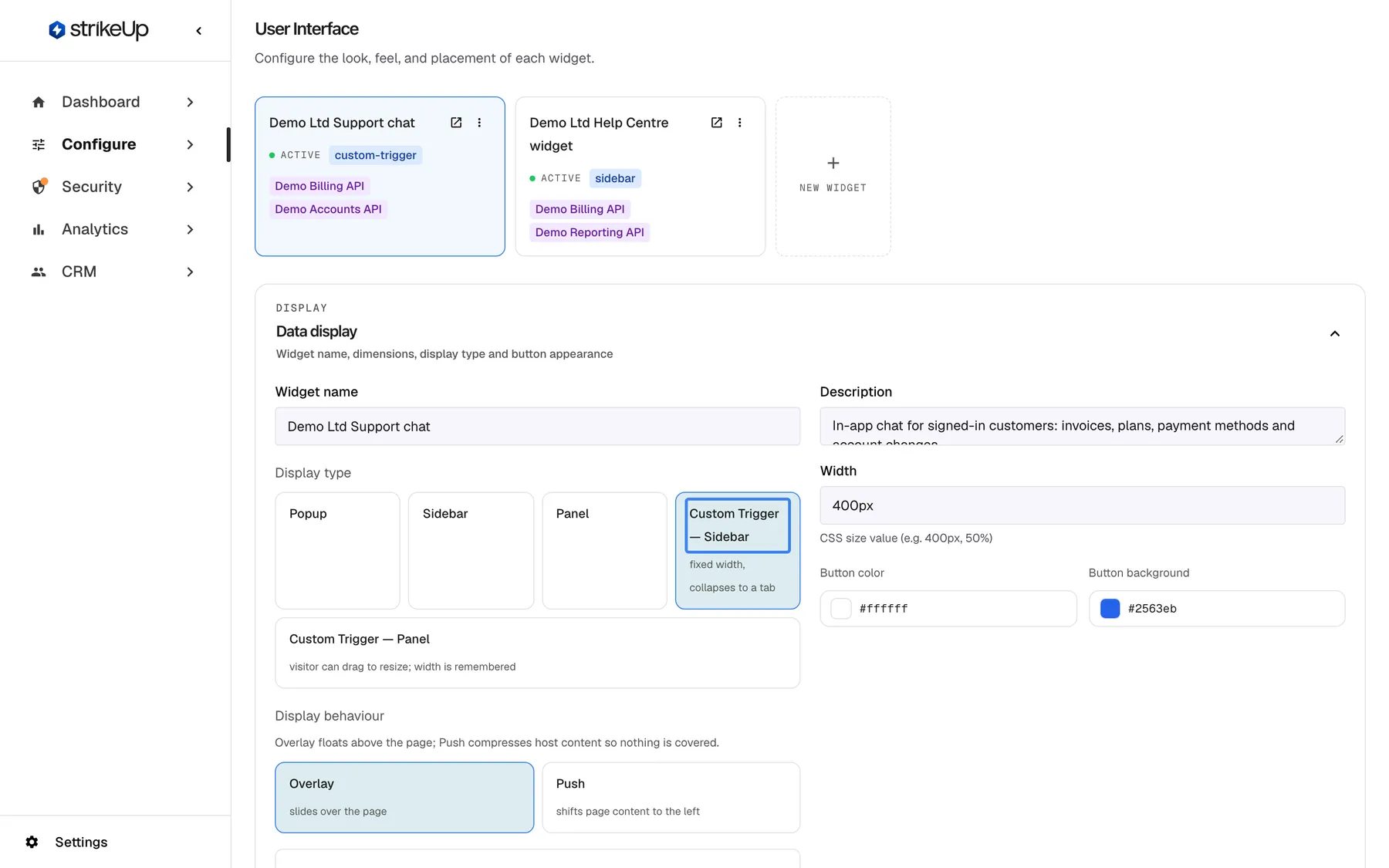 The User Interface page under Configure with the widget card "Demo Ltd Support chat" selected. The Data display section shows Widget name "Demo Ltd Support chat", the description, Width "400px", Button color "#ffffff" and Button background "#2563eb". Under Display type five options are offered: "Popup", "Sidebar", "Panel", the selected and highlighted "Custom Trigger — Sidebar" (fixed width, collapses to a tab) and "Custom Trigger — Panel" (visitor can drag to resize; width is remembered). Below, Display behaviour offers "Overlay" (selected) and "Push". The display type decides how the widget appears on your site.