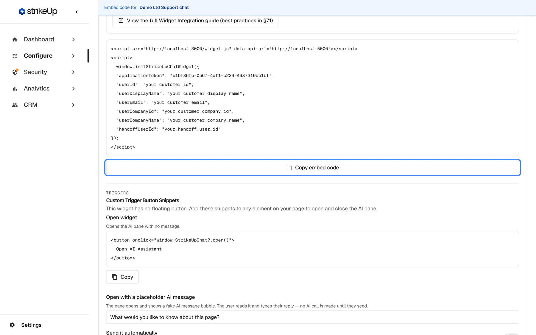 The embed code of the widget "Demo Ltd Support chat" on the Embed page. The code block holds a script tag that loads widget.js with a data-api-url attribute, then a call to window.initStrikeUpChatWidget with "applicationToken": "b1bf86fb-0567-4df1-c229-4987319bb1bf" and placeholders for "userId", "userDisplayName", "userEmail", "userCompanyId", "userCompanyName" and "handoffUserId". Below the block the highlighted "Copy embed code" button copies the whole snippet. Underneath begins "Custom Trigger Button Snippets" with "Open widget" and its button code.