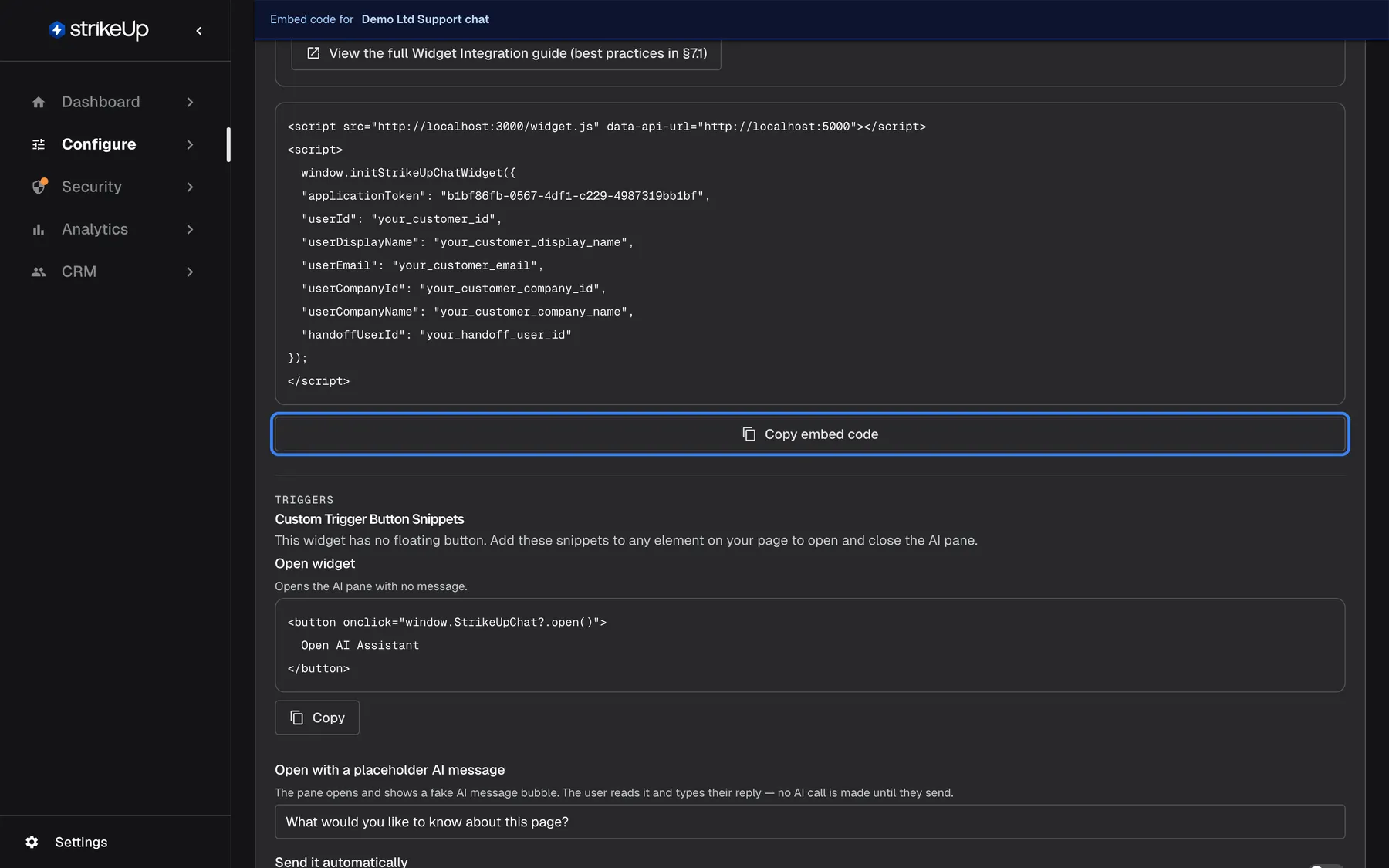 The embed code of the widget "Demo Ltd Support chat" on the Embed page. The code block holds a script tag that loads widget.js with a data-api-url attribute, then a call to window.initStrikeUpChatWidget with "applicationToken": "b1bf86fb-0567-4df1-c229-4987319bb1bf" and placeholders for "userId", "userDisplayName", "userEmail", "userCompanyId", "userCompanyName" and "handoffUserId". Below the block the highlighted "Copy embed code" button copies the whole snippet. Underneath begins "Custom Trigger Button Snippets" with "Open widget" and its button code.