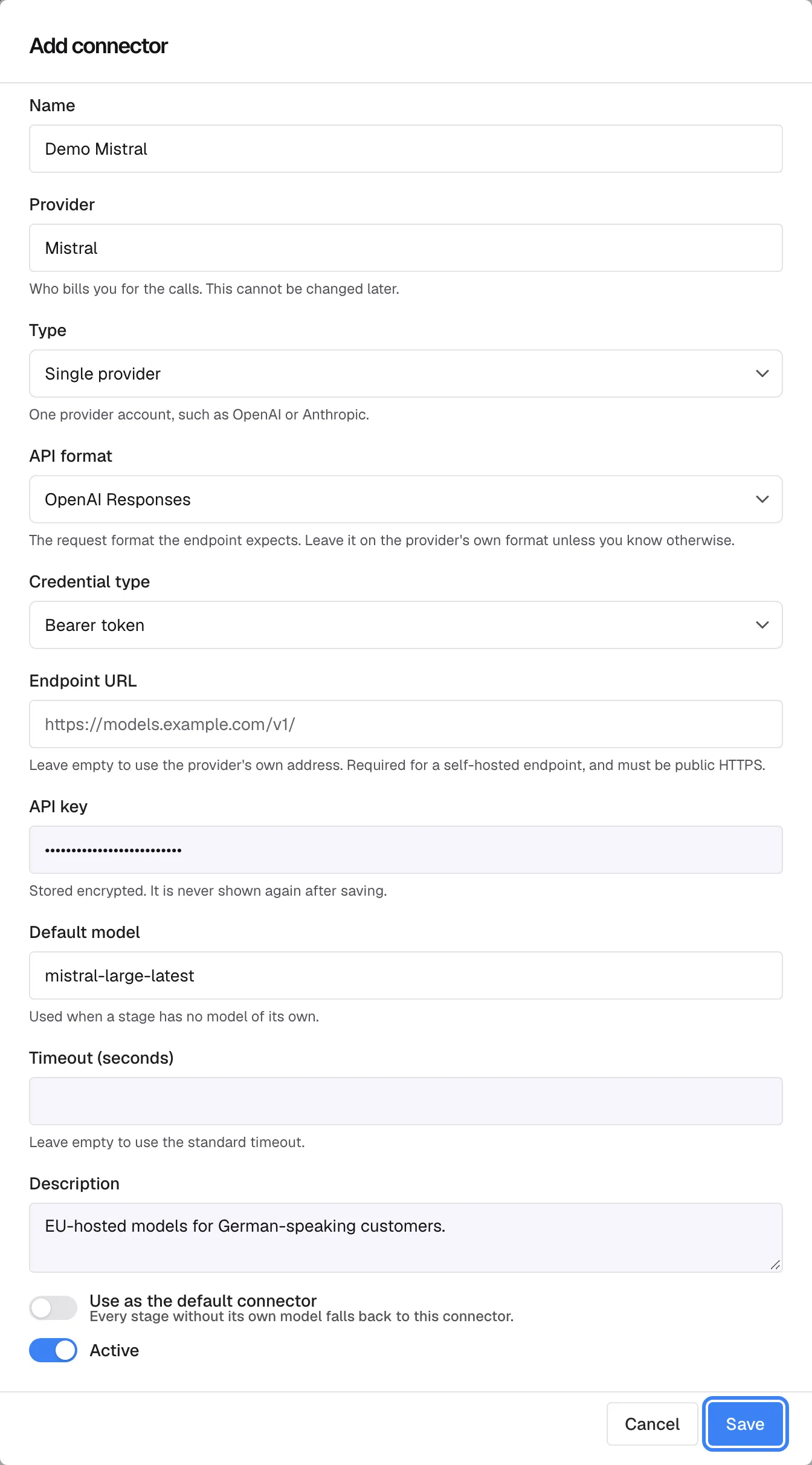 The "Add connector" dialog on the AI Gateway page, filled in: Name "Demo Mistral", Provider "Mistral" with the help text "Who bills you for the calls. This cannot be changed later.", Type "Single provider", API format, Credential type "Bearer token", an API key entered as hidden dots, Default model "mistral-large-latest" and Description "EU-hosted models for German-speaking customers.". The switches "Use as the default connector" and "Active" are at the bottom. The "Save" button in the dialog footer is highlighted; it creates the connector.