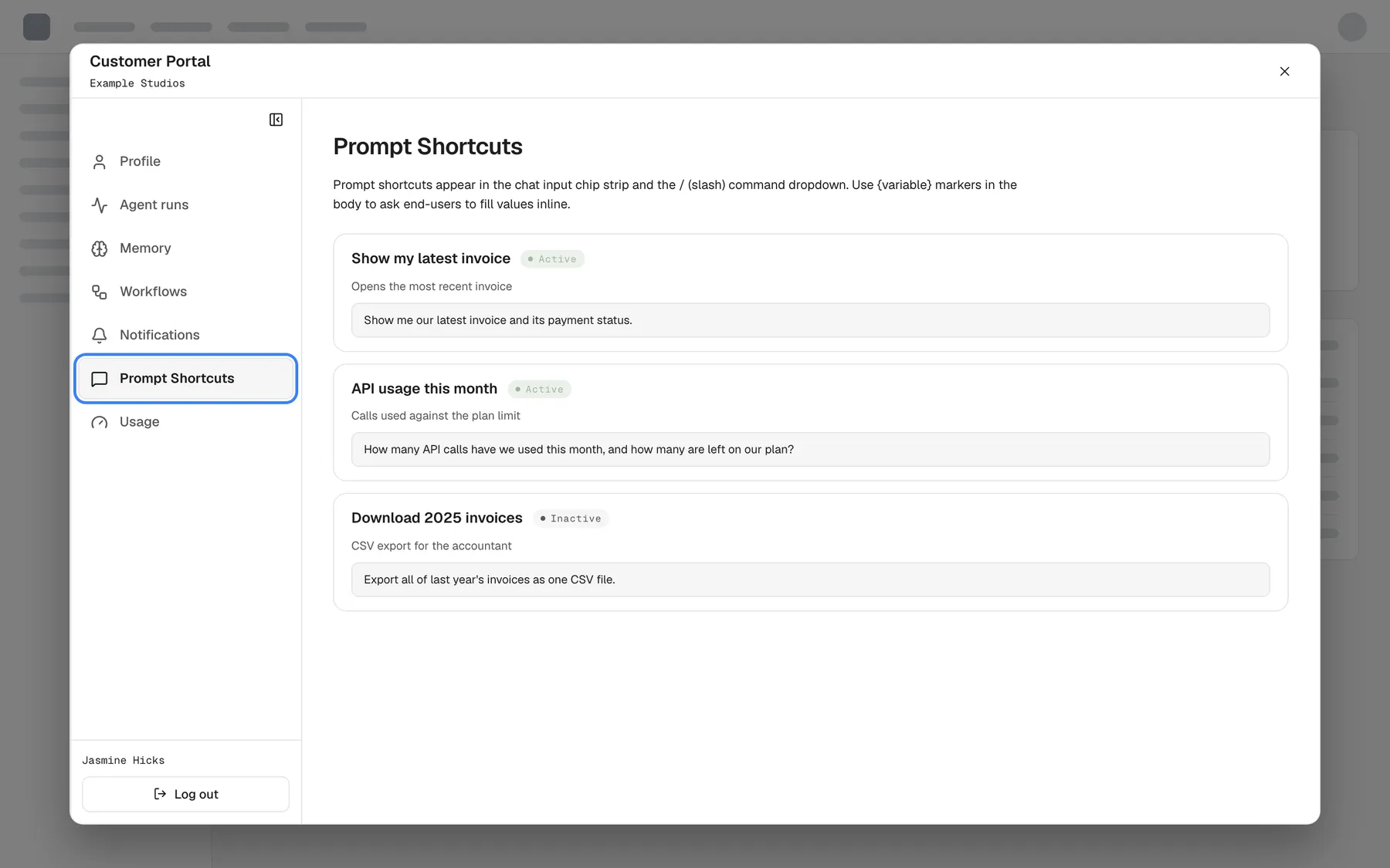 The Customer Portal as seen by Jasmine Hicks, a Member of "Example Studios". Her sidebar has only Profile, Agent runs, Memory, Workflows, Notifications, the highlighted and selected "Prompt Shortcuts" and Usage; Members, Knowledge Base, Skills and Settings are missing. The Prompt Shortcuts page lists the company's shortcuts read-only: "Show my latest invoice" and "API usage this month" (Active) and "Download 2025 invoices" (Inactive), each with its description and prompt text.