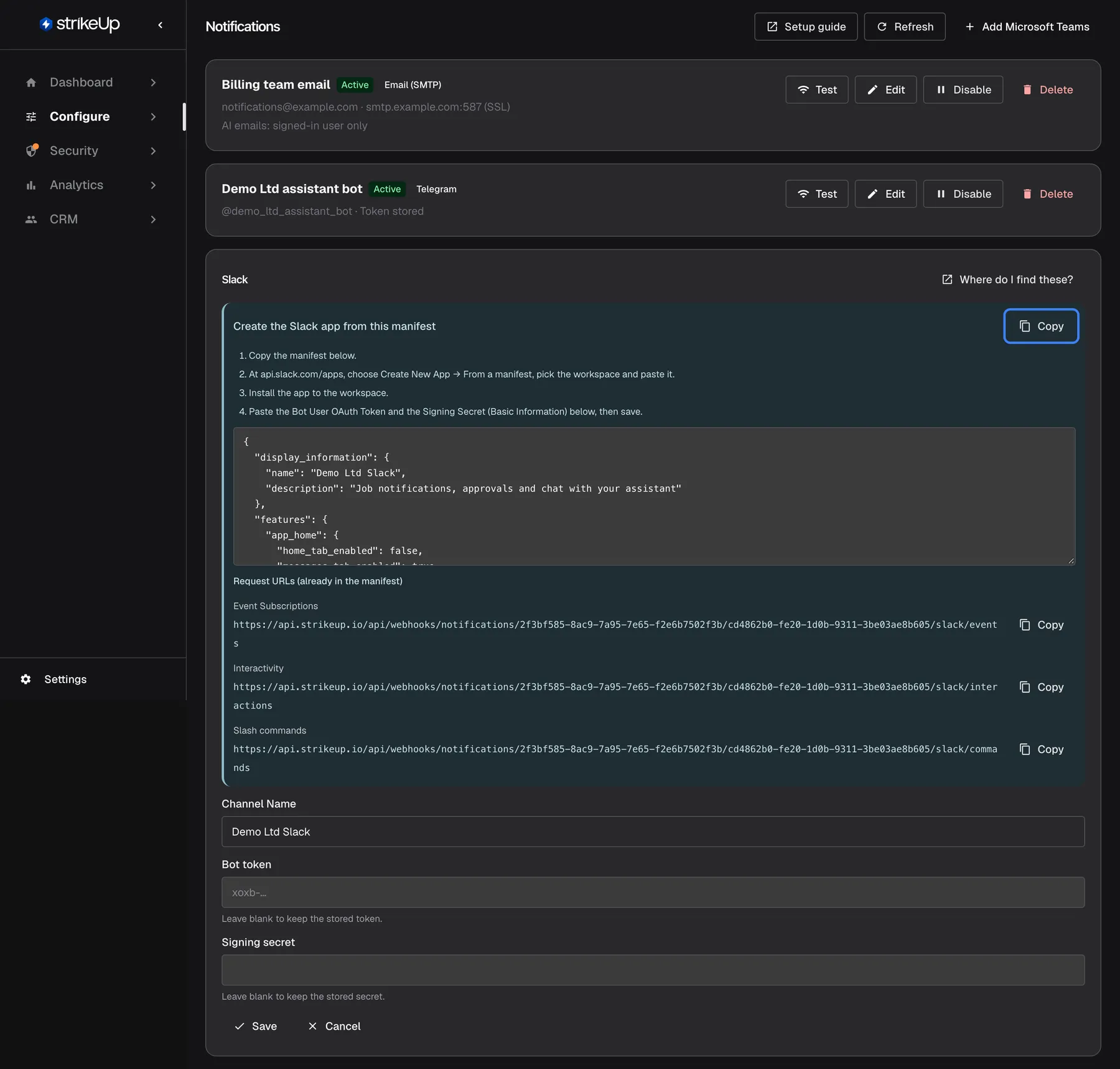 The Slack channel "Demo Ltd Slack" opened for editing. At the top a blue panel, "Create the Slack app from this manifest", lists four steps: copy the manifest, create the app at api.slack.com/apps from a manifest, install it to the workspace, then paste the Bot User OAuth Token and the Signing Secret and save. The highlighted "Copy" button copies the manifest shown in the box below it. Under "Request URLs (already in the manifest)" follow the Event Subscriptions, Interactivity and Slash commands addresses, each with "Copy". Below are "Channel Name", "Bot token" and "Signing secret", both empty with the hint to leave them blank to keep the stored values.
