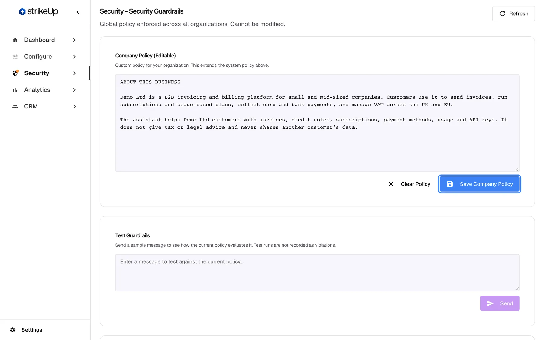 Step 6, the "Security - Security Guardrails" page, noting "Global policy enforced across all organizations. Cannot be modified.". The "Company Policy (Editable)" card holds a text box starting "ABOUT THIS BUSINESS" that describes Demo Ltd as a B2B invoicing and billing platform and says the assistant gives no tax or legal advice. Below the text, "Clear Policy" and the highlighted blue "Save Company Policy" button. The "Test Guardrails" card underneath lets you send a sample message to see whether the policy allows it.