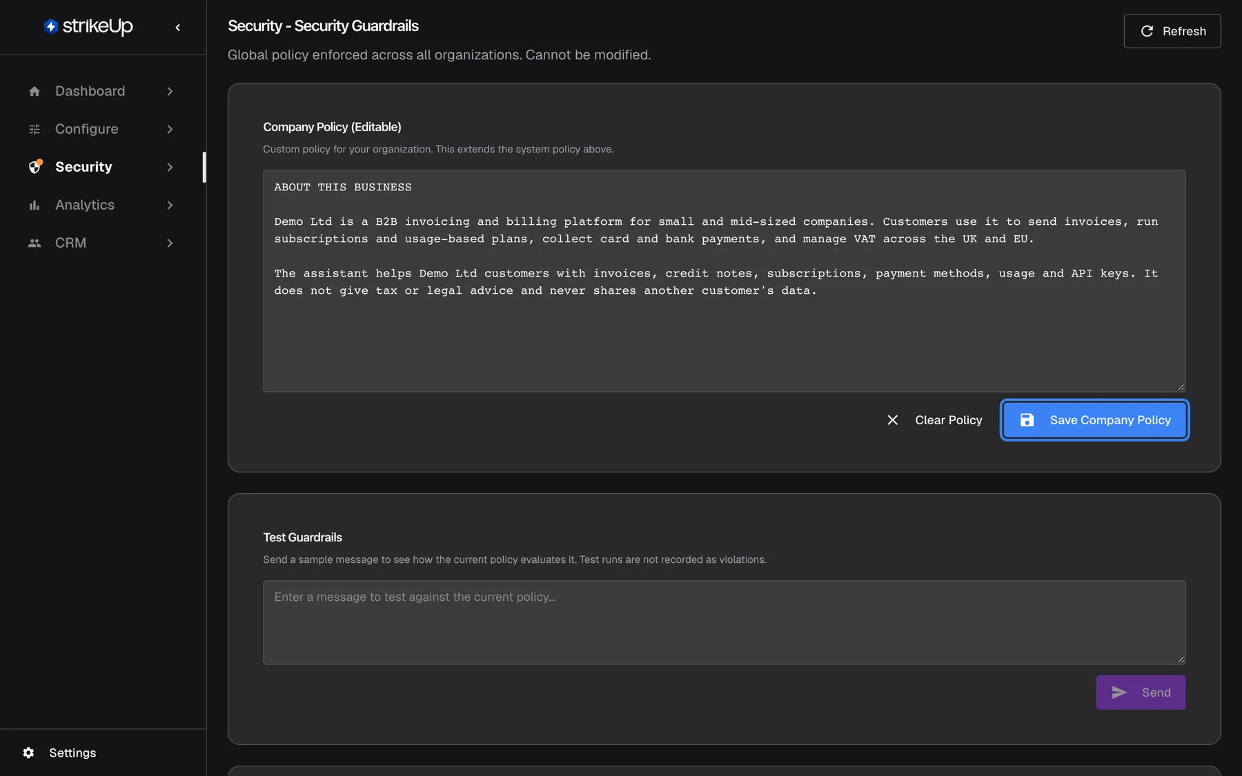 Step 6, the "Security - Security Guardrails" page, noting "Global policy enforced across all organizations. Cannot be modified.". The "Company Policy (Editable)" card holds a text box starting "ABOUT THIS BUSINESS" that describes Demo Ltd as a B2B invoicing and billing platform and says the assistant gives no tax or legal advice. Below the text, "Clear Policy" and the highlighted blue "Save Company Policy" button. The "Test Guardrails" card underneath lets you send a sample message to see whether the policy allows it.